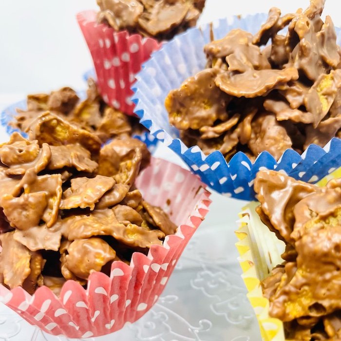 chocolate cornflake cakes in red, blue and yellow polka dot cupcake cases