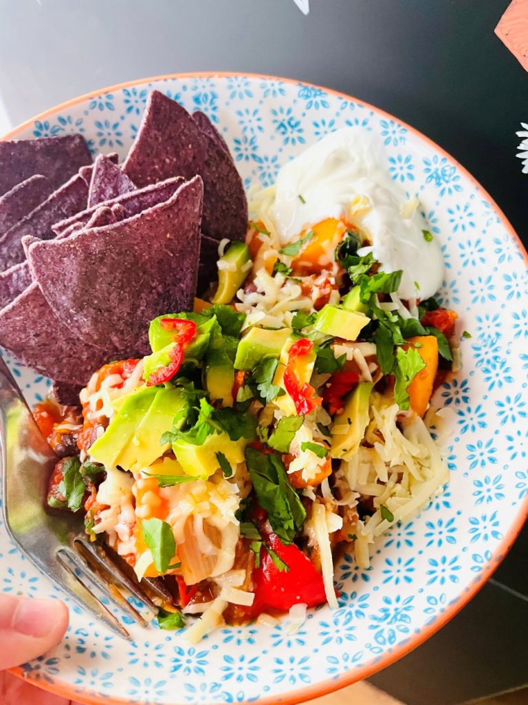 butternut and black bean chilli served with blue corn tortilla chips, grated cheese, avocado and fresh chilli slices
