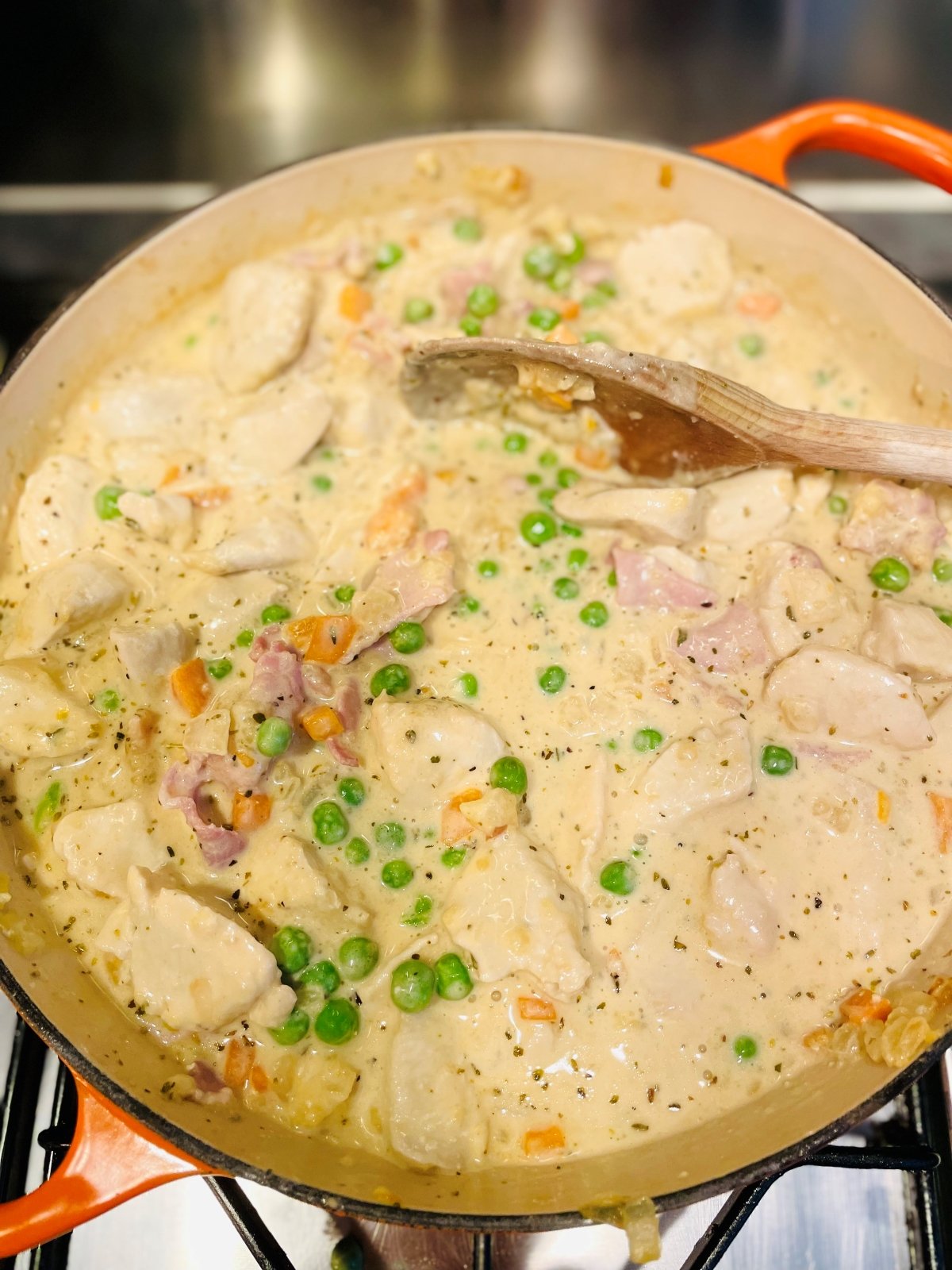 creamy chicken and bacon pie filling simmering in a skillet pan