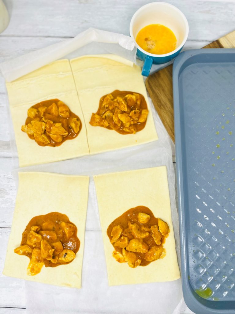 puff pastry squares with chicken tikka filling in the middle