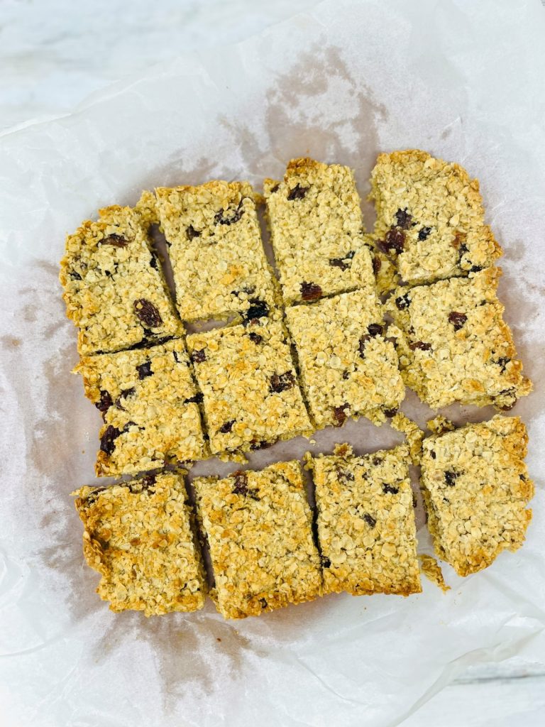 fruit flapjacks sliced into 12 pieces on a board